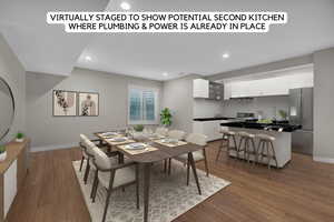 Dining room with wood finished floors, baseboards, and recessed lighting