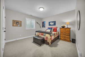 Bedroom featuring carpet floors and baseboards