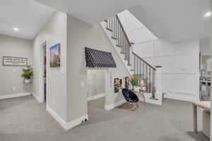 Staircase with carpet, baseboards, and recessed lighting