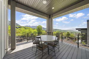 Wooden terrace with a mountain view and outdoor dining area