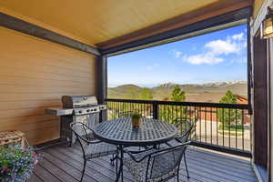 Deck featuring a mountain view and a grill