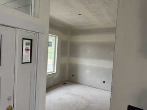 Foyer entrance featuring a textured ceiling