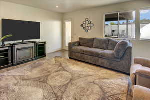 Living area with wood finished floors, recessed lighting, and baseboards
