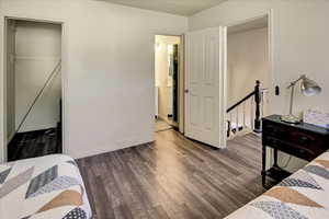 Bedroom with wood finished floors and baseboards