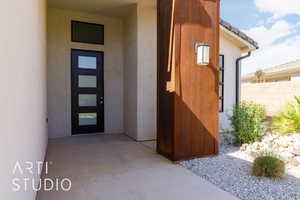View of exterior entry featuring stucco siding