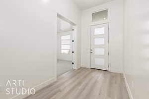 Foyer featuring light wood-type flooring and baseboards