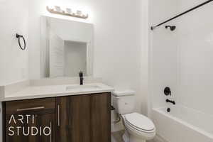 Bathroom featuring toilet, vanity, bathtub / shower combination, and wood finished floors