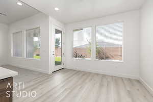 Unfurnished room with plenty of natural light, light wood finished floors, baseboards, and recessed lighting