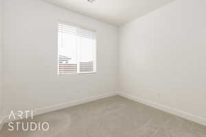 Empty room featuring carpet floors and baseboards