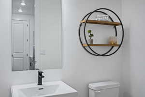 Half bath with a sink and toilet