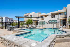 Community pool featuring fence, a residential view, and a patio area