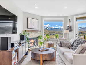 Living area with a mountain view, wood finished floors, a fireplace, and recessed lighting