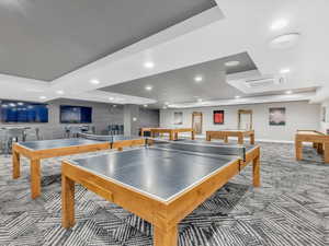 Recreation room featuring a tray ceiling, carpet flooring, billiards table, baseboards, and recessed lighting