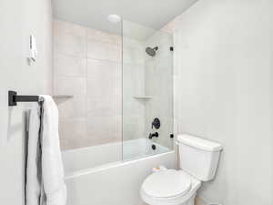 Bathroom with toilet and bathtub / shower combination