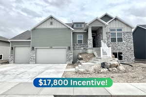 Craftsman-style house with stone siding, board and batten siding, concrete driveway, and a garage