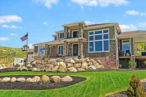 Prairie-style house with a balcony and stone siding