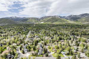 Aerial perspective of suburban area with a mountainous background