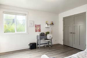 Bedroom featuring light wood finished floors and baseboards