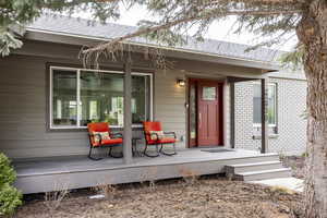 Doorway to property featuring brick siding