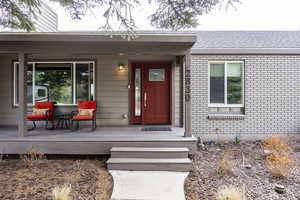 Property entrance featuring brick siding
