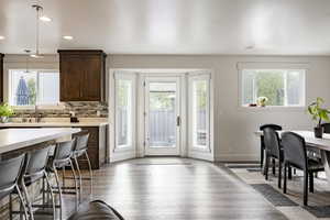 Dining space with plenty of natural light, wood finished floors, baseboards, and recessed lighting