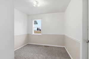 Unfurnished room featuring carpet and baseboards
