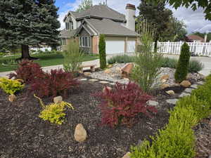View of yard with fence and a garage
