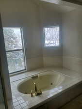 Bathroom featuring a tub with jets