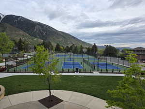 View of community featuring a tennis court and a mountain view
