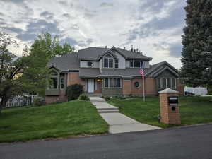 Traditional home with brick siding and a shingled roof