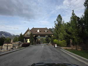 View of asphalt road featuring curbs and a mountain view
