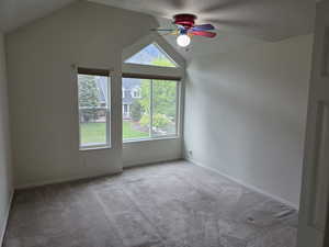 Bonus room featuring ceiling fan, lofted ceiling, plenty of natural light, carpet, and baseboards