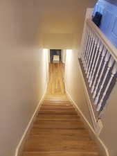 Staircase featuring wood finished floors