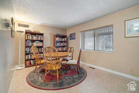 Dining space featuring baseboards, carpet, and a textured ceiling