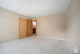 Carpeted empty room with baseboards