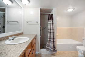 Full bathroom featuring a shower with curtain, a bath, vanity, toilet, and tile patterned flooring