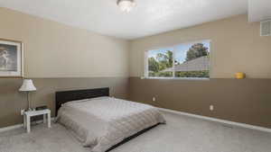 Bedroom featuring carpet floors and baseboards