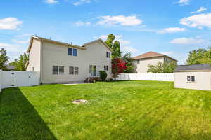 Rear view of property featuring a gate and a patio