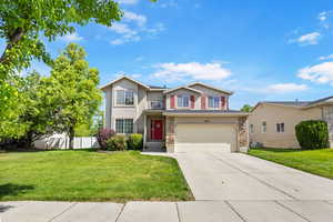 Traditional-style home featuring stone siding, concrete driveway, a garage, and stucco siding