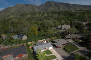 Aerial overview of property's location with a mountainous background and nearby suburban area