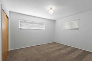 Unfurnished bedroom with carpet floors, a closet, and baseboards