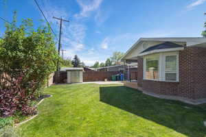 View of yard featuring a shed and an outdoor structure