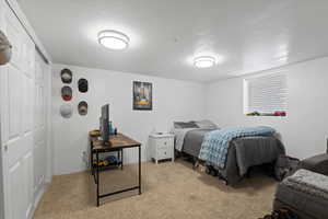 Bedroom with light carpet and a closet