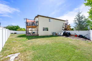 Back of house featuring central air condition unit and a deck