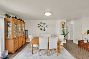 Dining room featuring light wood-type flooring and baseboards