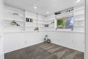 Spare room with a decorative wall, carpet flooring, recessed lighting, and built in features