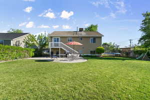 Back of property featuring a trampoline and a patio area