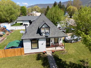 View of front of home featuring a shingled roof, a porch, and a mountain view