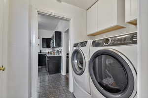 Laundry area with washing machine and clothes dryer and cabinet space