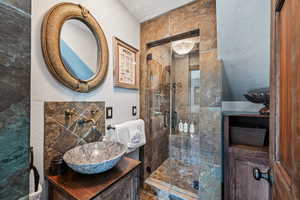 Full bathroom featuring a stall shower and vanity
